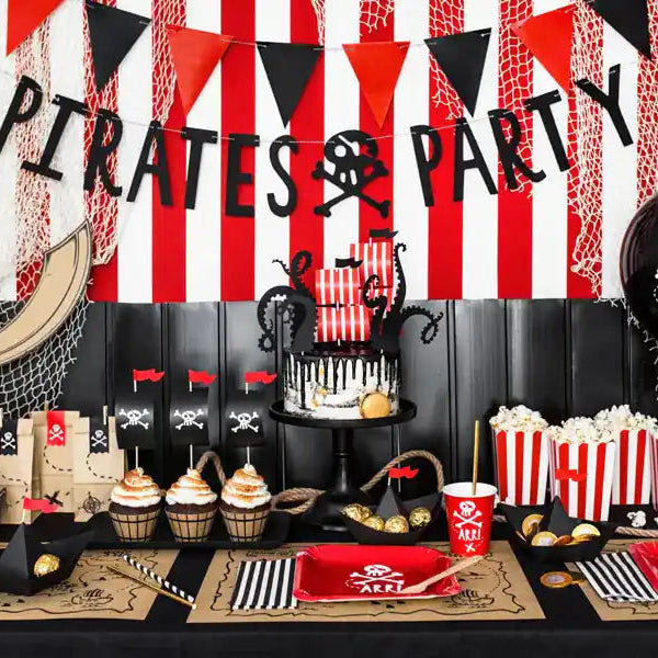 Pack de 6 vasos ecofriendly de piratas sobre mesa de cumpleaños temática